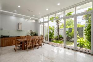 a kitchen and dining room with a table and chairs at Thao Dien Serenity Villa in Ho Chi Minh City
