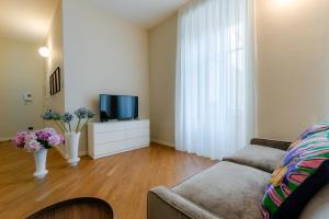 a living room with a couch and a tv at R Oleandro House in Como