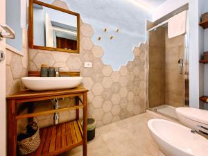 a bathroom with a sink and a mirror and a shower at Basso 61 Urban Oasis with Private Mini Pool & Courtyard - Families & Groups in Palermo