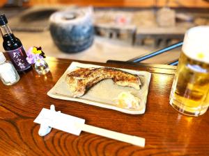 a plate of food on a table with a drink at Yuuzuru in Ito