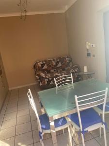 a living room with a table and chairs and a couch at Home Sweet Home in Asti