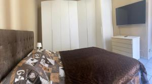 a bedroom with a bed and a dresser and a tv at Home Sweet Home in Asti +5 photos