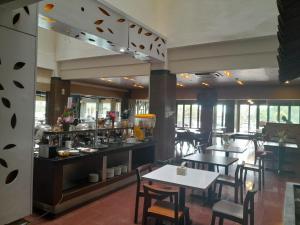 a restaurant with tables and chairs and a counter at d'JHIA HOTEL in Nagoya