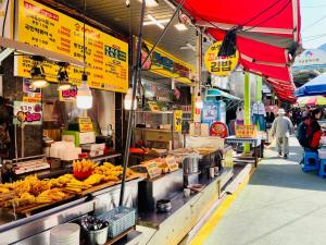 a market with a bunch of bananas on display at Everville, Gaegeum Everville 304 #Stairs to 3rd floor in Busan