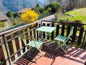 a table and two chairs sitting on a balcony at Villa Carla - Bosco in Ledro
