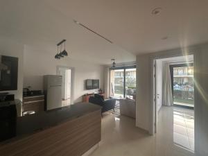 a living room with a kitchen and a living room with a refrigerator at G Cribs Hotel Apartment 2BR in Hurghada