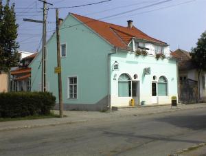 a blue and white house on the side of a street at Pensiunea Erika in Praid