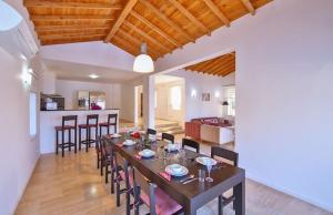 a dining room and living room with a table and chairs at Villa Basil in Kaş