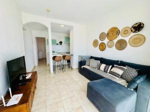 a living room with a blue couch and a table at Little Gem in Matagorda