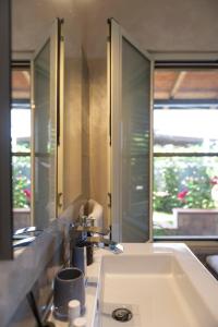 a bathroom with a sink and a large mirror at House garden in Sperlonga +47 photos