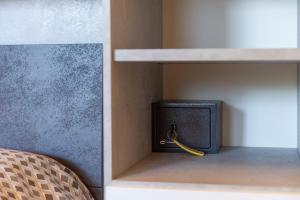 a small black tv sitting in a closet at House garden in Sperlonga
