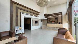 a lobby with two chairs and a living room at Hotel n pavilion in Mysore