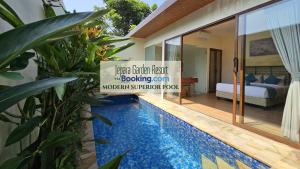 a villa with a swimming pool next to a bedroom at Jepara Garden Resort in Jepara