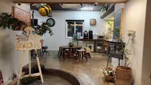 a room with a table and chairs and plants at World House Hotel in Pohang