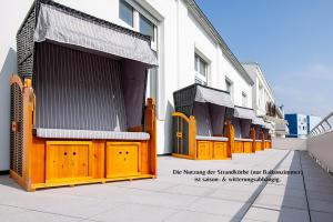 a row of wooden gates on the side of a building at Logierhaus Extra in Norderney