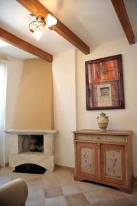 a living room with a fireplace and a ceiling fan at L' antico Borgo in Terlizzi +1 photo