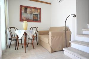 a living room with a table and a chair at L' antico Borgo in Terlizzi