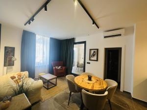 a living room with a table and chairs at Apartments Urban in Poreč