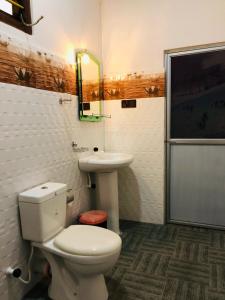 a bathroom with a toilet and a sink at Calm Garden Cabanas in Tangalle +93 photos