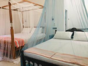 Postel nebo postele na pokoji v ubytování Calm Garden Cabanas