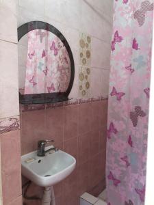 a bathroom with a sink and a mirror at Готель Оазис in Chernivtsi