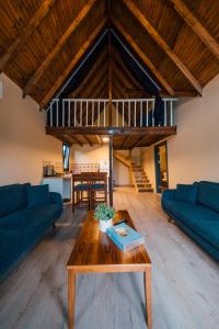 a living room with two blue couches and a table at Varuna Bungalov Evleri in Sapanca