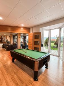 a pool table in the middle of a living room at Puigcerda Park Hotel in Puigcerdà