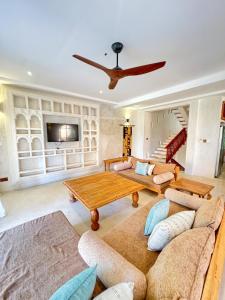 a living room with a couch and a table at Al Mahali Villas Diani Beach in Diani Beach