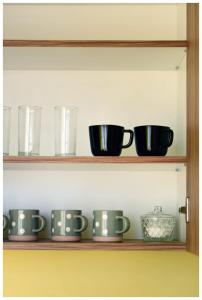 a shelf with bowls and cups on it at Color 24 - Złoty Punkt in Stalowa Wola +10 photos