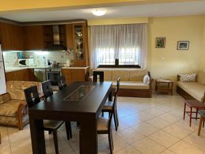 a kitchen and a living room with a table and chairs at Maisonette Triglia Sea View in Néa Tríglia +13 photos