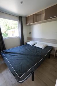 a large bed in a room with a window at Ty Névez in Trégunc