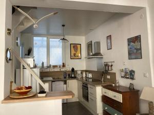 a kitchen with a sink and a counter in it at Chez Tipoulot - maison de pêcheur à 2 pas du port in Fécamp