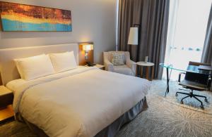 a hotel room with a bed and a desk and a chair at Hotel Skypark Central Seoul Pangyo in Seongnam +64 photos