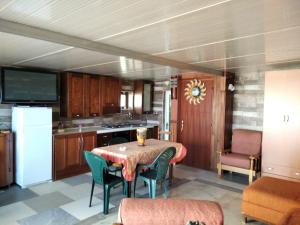 a kitchen with a table and some chairs and a table and a kitchen at Villa Immacolata in Sava