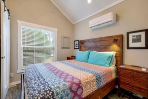 a bedroom with a bed and a window at Riverfront Tiny House with Fire Pit in Seguin, Texas in Seguin