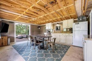 a kitchen with a table and chairs and a refrigerator at Riverfront Tiny House with Fire Pit in Seguin, Texas in Seguin