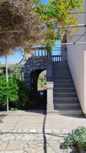 a set of stairs with a stone archway in a building at Apartment Lovor in Krk