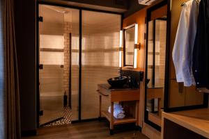 a bathroom with a sink and a glass shower at Letoh Letoh Sevilla in Seville +57 photos