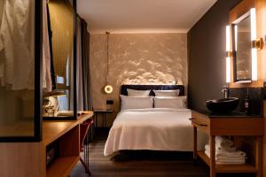 a hotel room with a bed and a sink at Letoh Letoh Sevilla in Seville