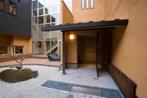 an entrance to a building with a black awning at Onsen Ryokan Yamaki in Nasushiobara