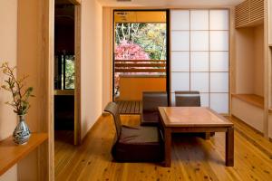 a dining room with a table and a chair at Onsen Ryokan Yamaki in Nasushiobara
