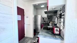 a kitchen with a refrigerator and a counter top at Casamea - Vue Mer, Clim & Parking, Proche Plage in Ajaccio