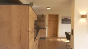 a room with wooden cabinets and a hallway at Ferienwohnung Reitemann in Oy-Mittelberg +23 photos