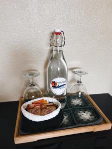 a bottle and a bowl of food on a tray at Seaview Mansion Apartment 1 in Dalaguete +15 photos