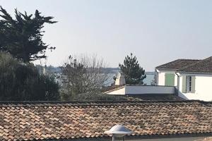 a roof of a house with a view of the water at Apartment with sea view parking garden and beach access in La Flotte