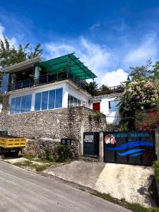 a building with a green roof on top of it at Seaview Mansion Apartment 1 in Dalaguete