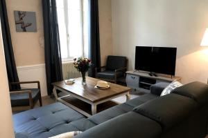a living room with a couch and a table at Cozy House with Free Private Parking in Saint-Martin-de-Ré
