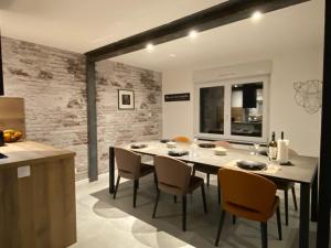 a kitchen and dining room with a table and chairs at Beach house Maison de plage les pieds dans l eau in Plérin