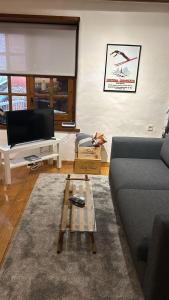 a living room with a couch and a coffee table at Era Caseta - TREDÒS in Tredós +13 photos