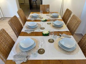 a table with plates and dishes on top of it at Villa Olivija-direkt am Strand! in Stara Novalja